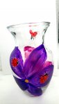 vase with ladybirds on bright purple and pink flowers