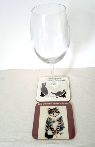Photo of cat coasters with a wine glass