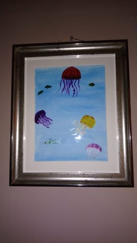 Painting with jellyfish in glass paint and a blue acrylic background