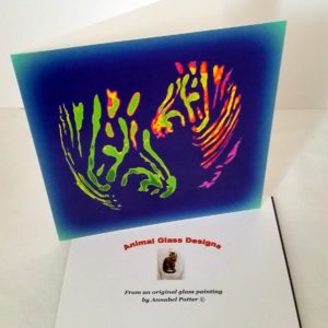 Colourful card with two multi-coloured zebras
