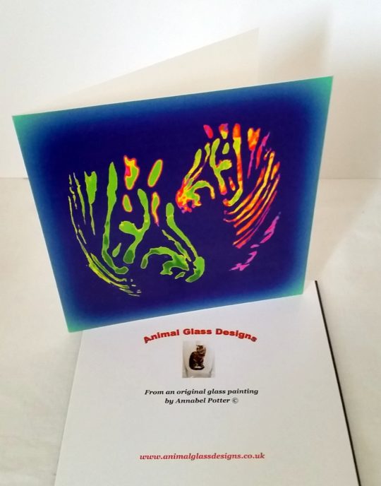 Colourful card with two multi-coloured zebras