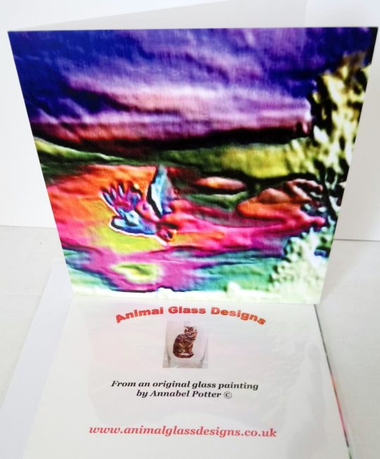 Colourful greeting card with an owl in flight with a multi-coloured abstract background