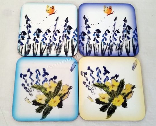 Floral set of wood coasters with bluebells, primrose and butterflies