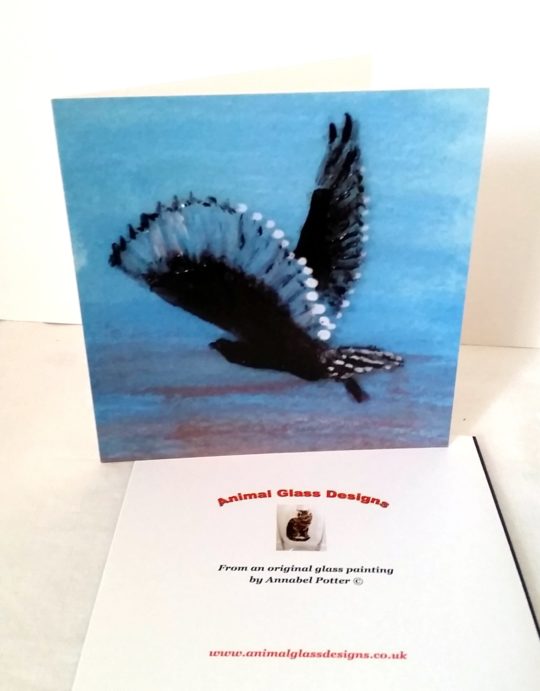 Greeting card with an owl flying at sunrise