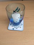 Abstract dragonfly coaster shown with a candle holder