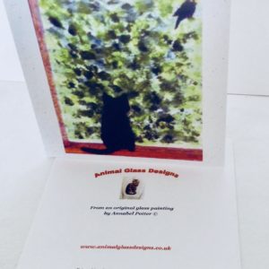 Greeting card with a black ct watching a blackbird in a bush