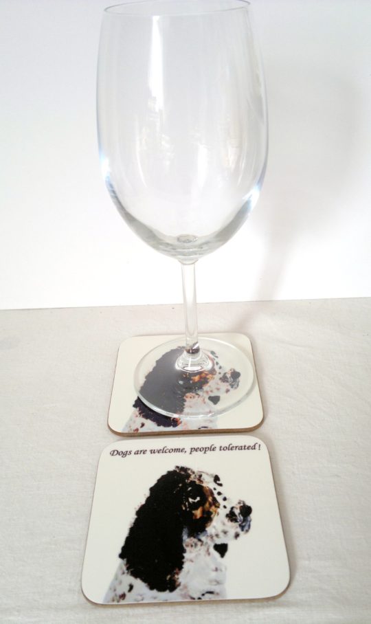 A photo of a black and white Springer Spaniel drinks coaster with a wine glass