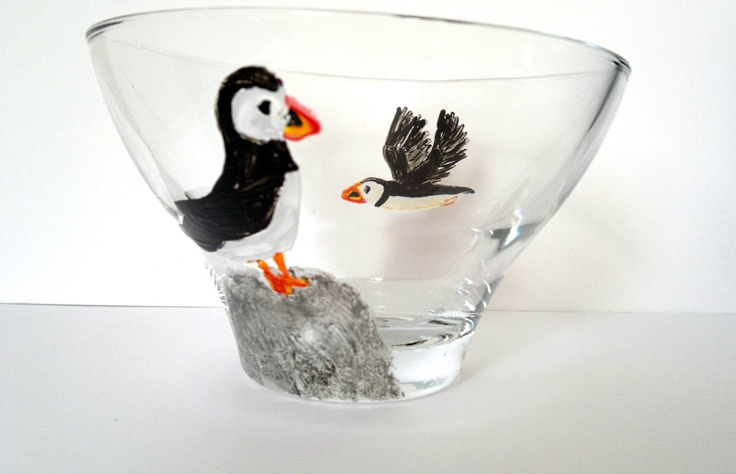 Hand painted glass bowl with a puffin in flight and a puffin on a rock