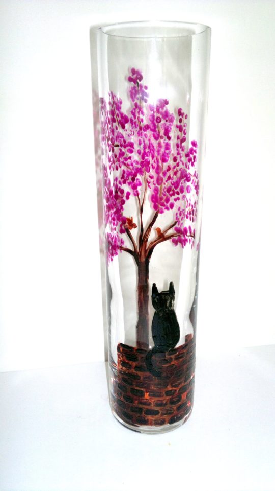 Bud vase glass painting with a black cat on a wall watching a bird in a blossom tree