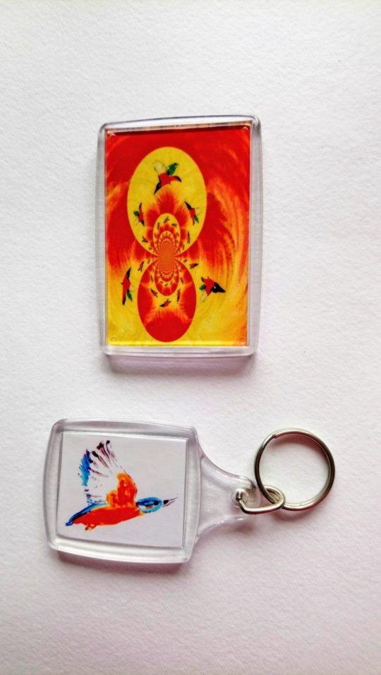 Flying kingfisher artwork on a keyring and fridge magnet